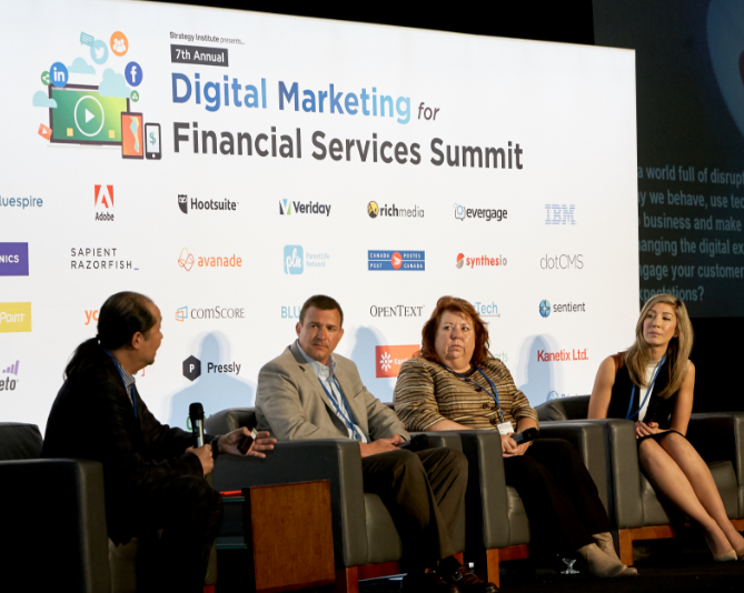 panel talking in front of backdrop with sponsors